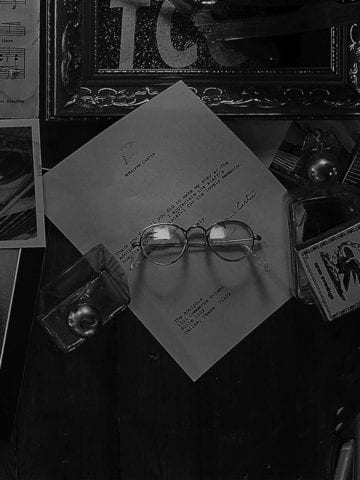 Letter from former President Jimmy Carter and reading glasses resting on top